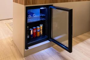 a black refrigerator with drinks inside of it at Avwan Hotels Collection in İzmir +34 photos