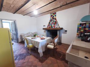 a dining room with a table and a fireplace at Domus Nirale in Bagnoregio
