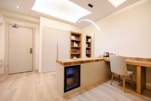 a kitchen with a fireplace and a desk with a chair at Avwan Hotels Collection in İzmir