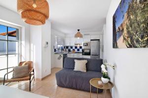 a living room with a couch and a table at Tavira Mar in Cabanas de Tavira
