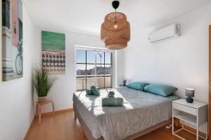 a bedroom with a large bed with a window at Tavira Mar in Cabanas de Tavira