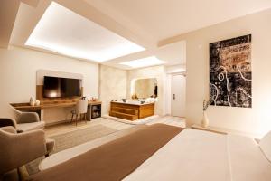 a bedroom with a bed and a tv in a room at Avwan Hotels Collection in İzmir