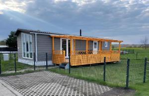 a small yellow house with a fence in front of it at Ferienhaus Concordia in Friedrichsaue