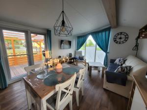 a dining room and living room with a table and chairs at Ferienhaus Concordia in Friedrichsaue