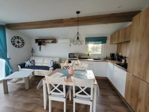 a kitchen and living room with a table and chairs at Ferienhaus Concordia in Friedrichsaue +7 photos