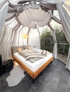 a bedroom with a canopy bed with stars on it at Chalet Sternenzauber in Waasen