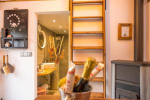 a kitchen with a counter with a bottle of wine at Chalet Sternenzauber in Waasen +30 photos