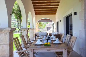 a wooden table and chairs on a patio at Villa Mar y Muntana in Banyalbufar