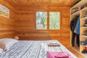 a bedroom with a bed and a window at Le Colibri in La Ciotat