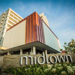 a building with a sign in front of it at Midtown Hotel Samarinda in Samarinda