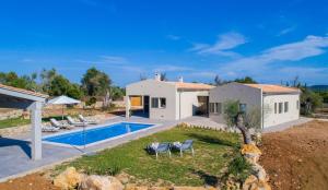 a villa with a swimming pool and a house at Can Colomer Ferragut in Artá