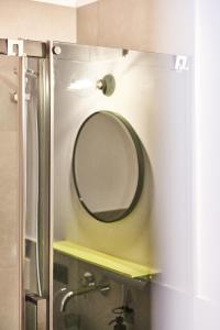 a bathroom with a mirror and a sink and a shower at Alte Seifensiederei - Cisco in Bad Tölz