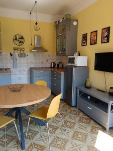 a kitchen with a table and chairs and a refrigerator at Ilgattonero in Orero