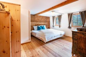 a bedroom with a bed and wooden floors at Innerforchhof Schnals in Madonna