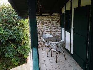 two chairs and a table on a patio at Domaine Xixtaberri in Cambo-les-Bains +12 photos