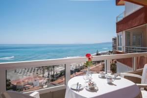 a table on a balcony with a view of the ocean at Bloque 76 in Torrox