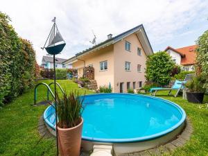 a swimming pool in the yard of a house at Ferienwohnung Bruttel in Gaienhofen