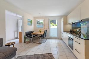 a kitchen and living room with a table and a couch at Ferienwohnung Bruttel in Gaienhofen