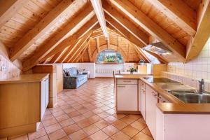 a kitchen with a vaulted ceiling with wooden beams at Mansardenwohnung Egart in Resia