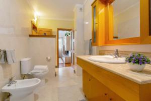 a bathroom with a sink and a toilet at Refugio Dourado in Água de Pena +19 photos
