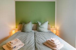 a bedroom with a bed with towels on it at Fewo Luisa in Bad Zwischenahn