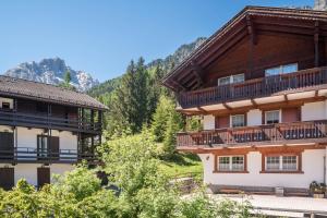 a view of two buildings with balconies and trees at Casa Lorenz 1 in Canazei