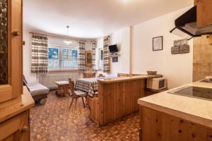 a kitchen with a table and a dining room at Casa Lorenz 1 in Canazei