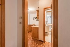 a kitchen with a sink and a mirror at Casa Lorenz 1 in Canazei +16 photos