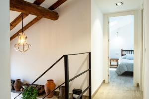 a hallway with a staircase and a light fixture at La Carbonera in Alaejos