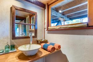 a bathroom with a sink and a mirror at Le Sabel - Cabanon in Mourèze +68 photos