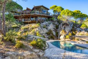 a house on top of a hill with a pool at Le Sabel - Cabanon in Mourèze