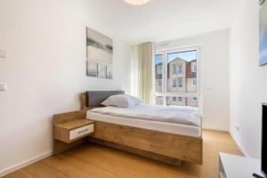 a bedroom with a bed and a large window at Apartment-Ernst in Finsterwalde