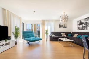 a living room with a couch and a tv at Apartment-Ernst in Finsterwalde