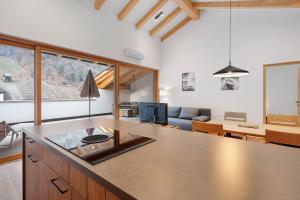 a kitchen and living room with a table and a couch at Matscherhof Lana in Lana