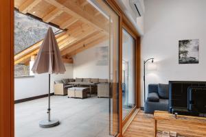a living room with a sliding glass door leading into a living room at Matscherhof Lana in Lana