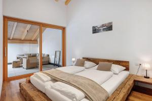 a bedroom with a large bed and a living room at Matscherhof Lana in Lana +104 photos