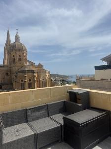 a view of a building from the roof of a building at Azure Dome Residences in Għajnsielem