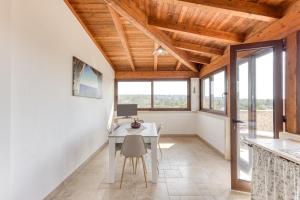 a home office with a desk and windows at Villa Liscedde Leuca in Castrignano del Capo