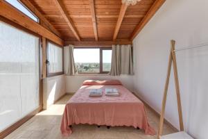 a bedroom with a bed in a room with a window at Villa Liscedde Leuca in Castrignano del Capo