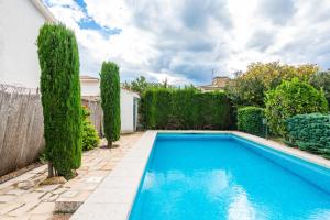 a swimming pool in the backyard of a house with trees at Mario in Vinarós