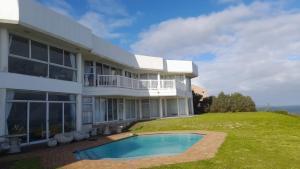 a house with a swimming pool in front of it at The White House Guesthouse in East London