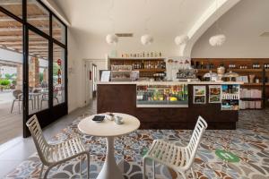 a restaurant with a table and chairs and a counter at Tenuta Vigna Corallo - Mimosa in Otranto