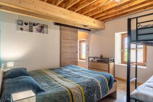 a bedroom with a bed and a television in a room at Les Bellevues in Moye