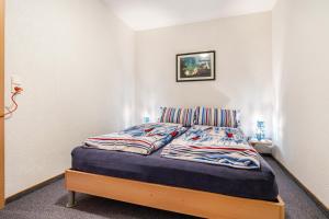 a bed in a bedroom with a picture on the wall at Ferienwohnung Mit Maritimen Flair in Lohme