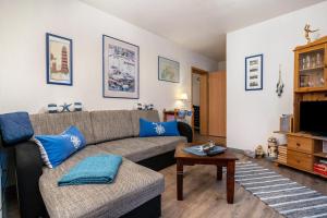 a living room with a couch and a table at Ferienwohnung Mit Maritimen Flair in Lohme