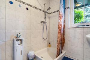 a bathroom with a shower and a bath tub at Ferienwohnung Mit Maritimen Flair in Lohme +17 photos