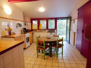 a kitchen with a table and chairs in it at Domaine Xixtaberri in Cambo-les-Bains