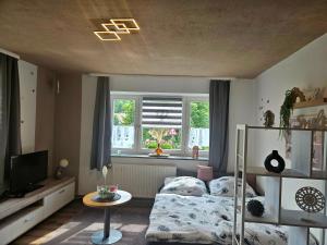 a bedroom with a bed and a window at Auszeit zwischen Fellnasen in Bischofsgrün