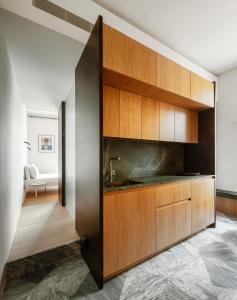 a kitchen with wooden cabinets and a sink at Stilla, San Mikiel in Senglea