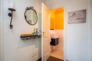 a bathroom with a sink and a mirror on the wall at Duplex Can Roses in Moscari +17 photos